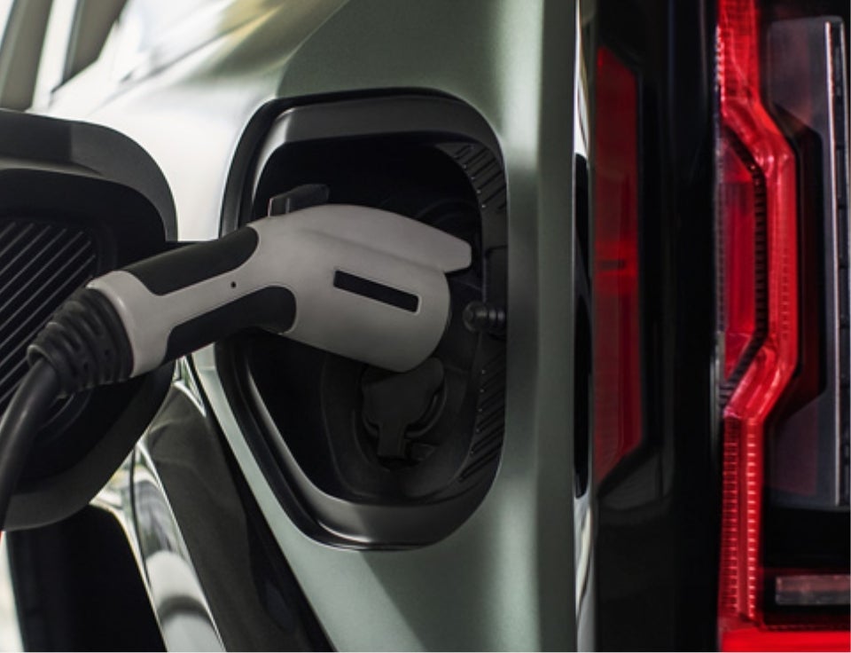 Close up of charging port with charger plugged in on a GMC Hummer EV SUV - Gay Buick GMC in Dickinson TX